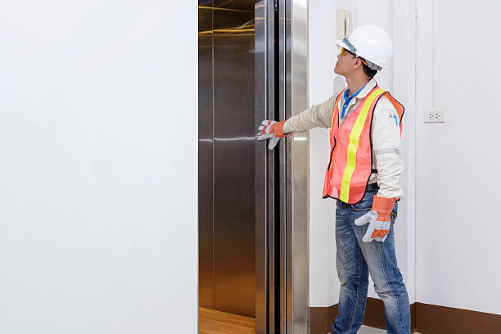 Technician - Engineer investigate work adjustment mechanism lifts the elevator.